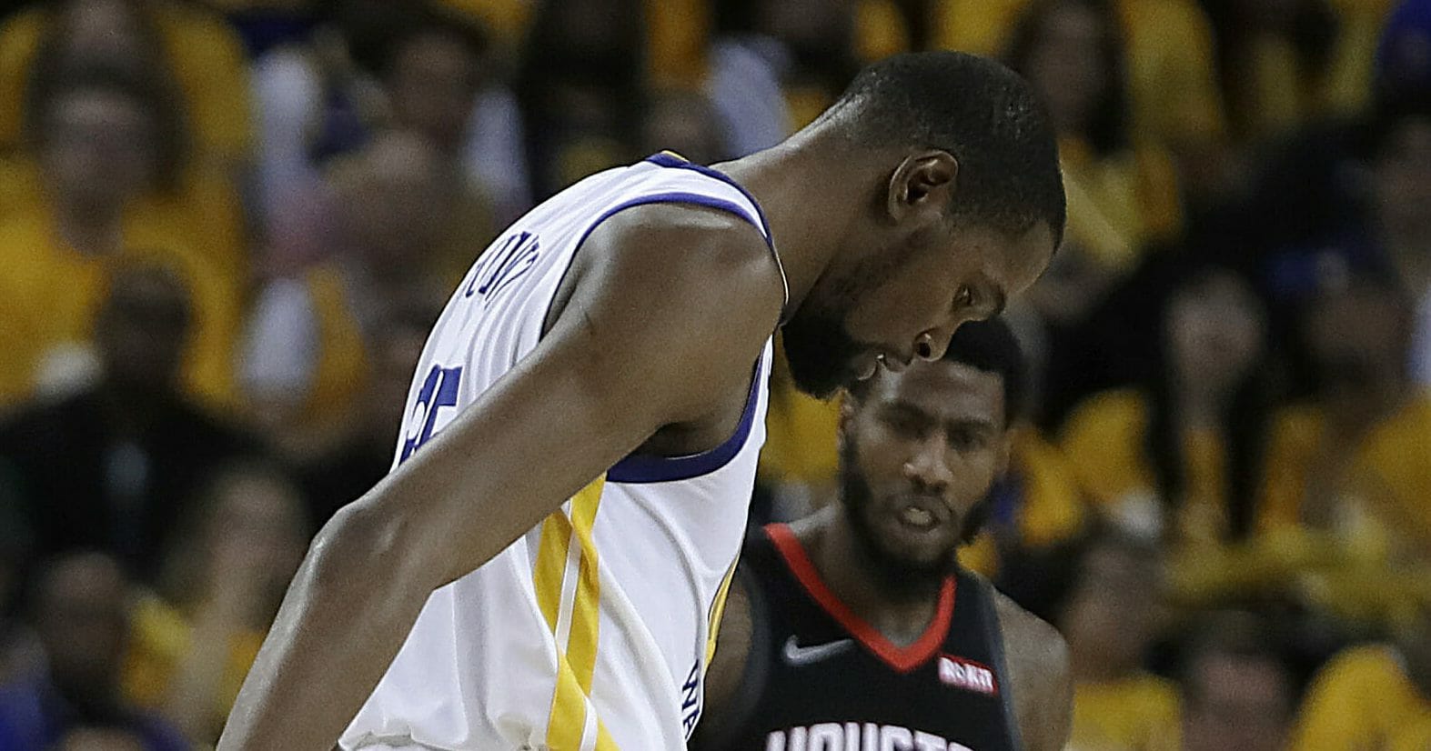 The Golden State Warriors' Kevin Durant limps off the court.