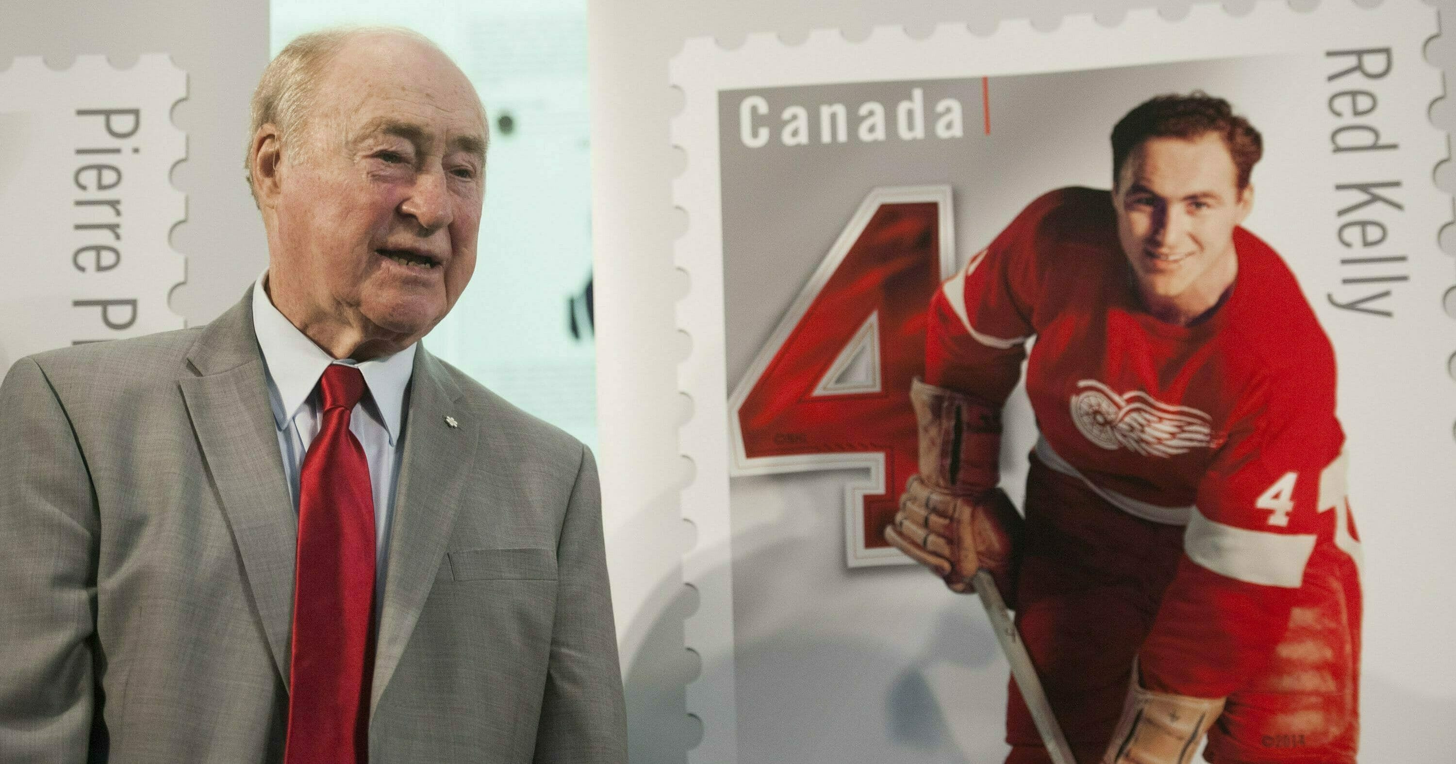 Red Kelly stands beside his Canadian stamp during the Feb 1, 2019, unveiling of a series featuring defensemen from the original six NHL teams at the Hockey Hall of Fame in Toronto.