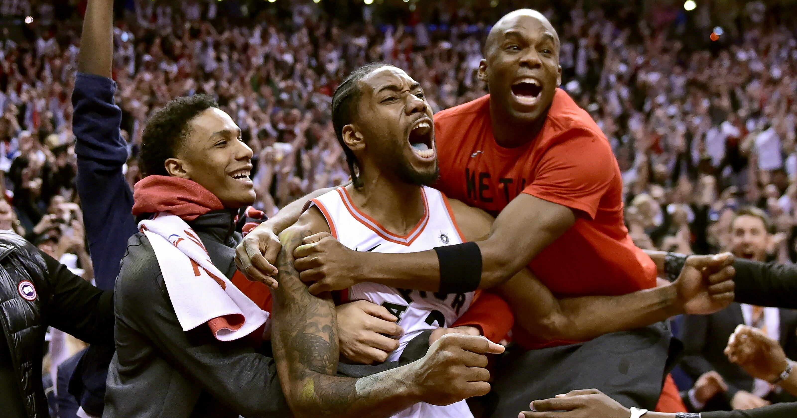 Toronto Raptors forward Kawhi Leonard and his teammates celebrate his last-second basket.