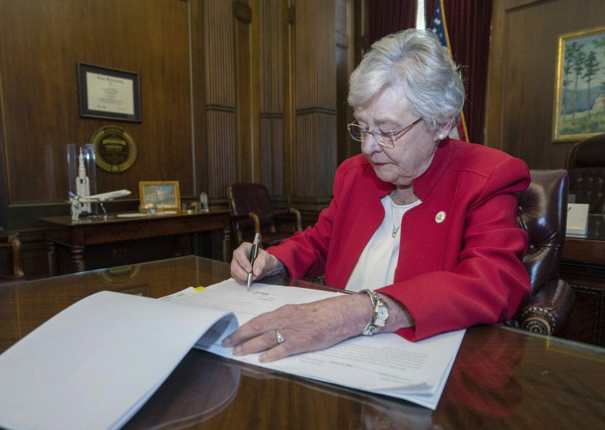 This photograph released by the state shows Alabama Gov. Kay Ivey signing a bill that virtually outlaws abortion in the state on Wednesday, May 15, 2019, in Montgomery, Alabama. (Hal Yeager / Alabama Governor's Office via AP)