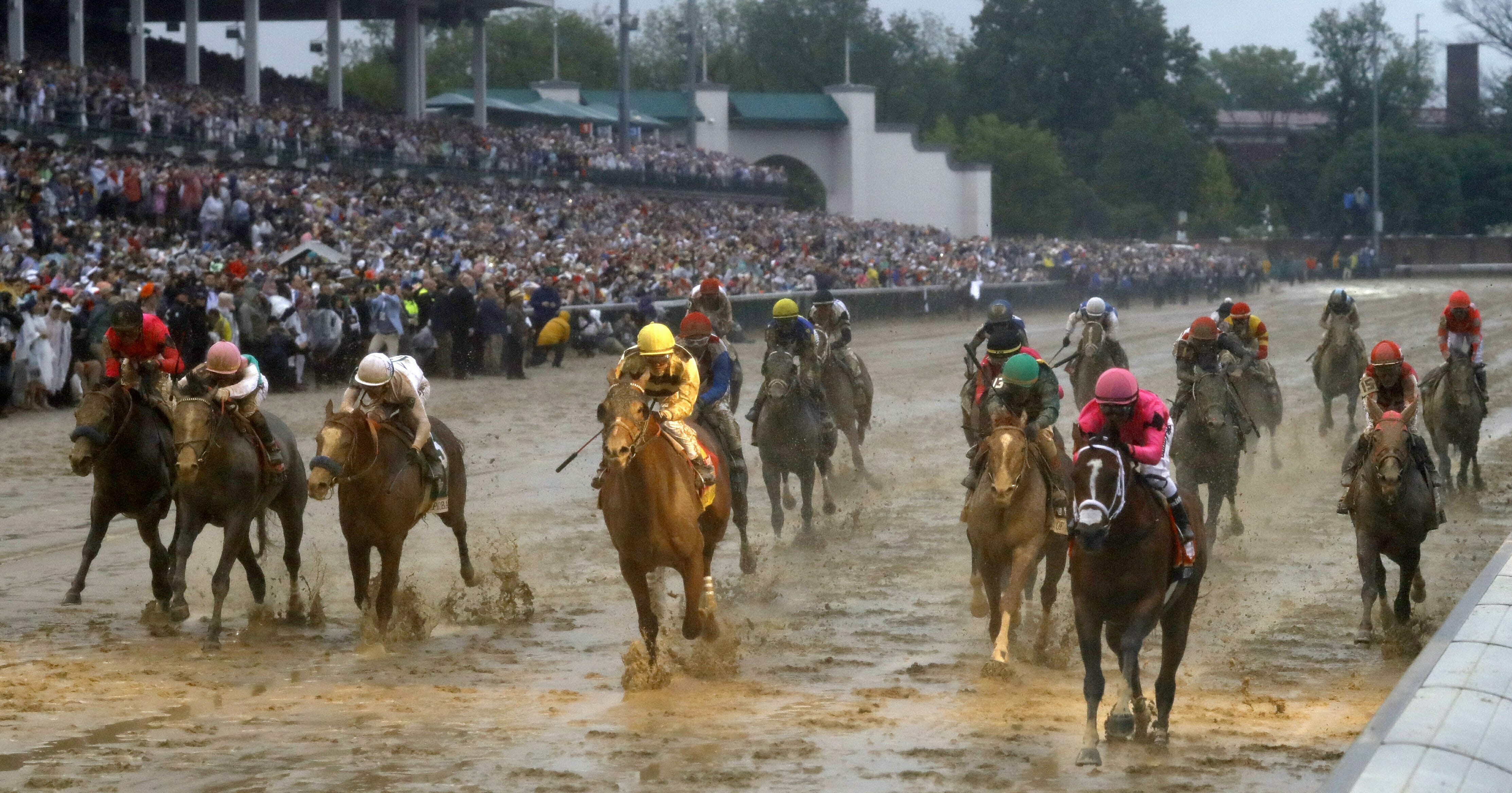 Luis Saez rides Maximum Security across the finish line first, followed by Flavien Prat on Country House, during the 145th running of the Kentucky Derby.