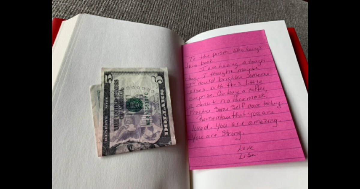 Photo of $5 and a note inside the book.