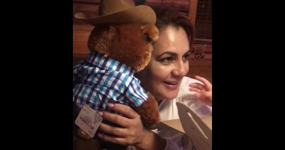 Quijada holds the bear up to her ear.