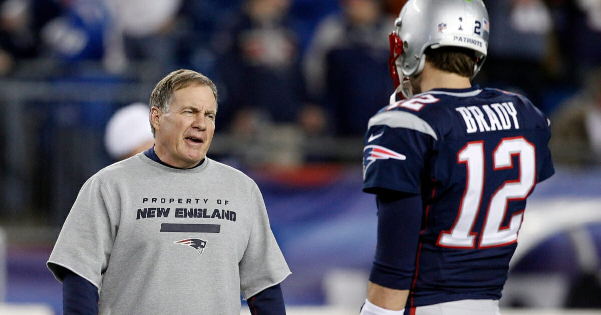New England Patriots head coach Bill Belichick, left, talks to quarterback Tom Brady.