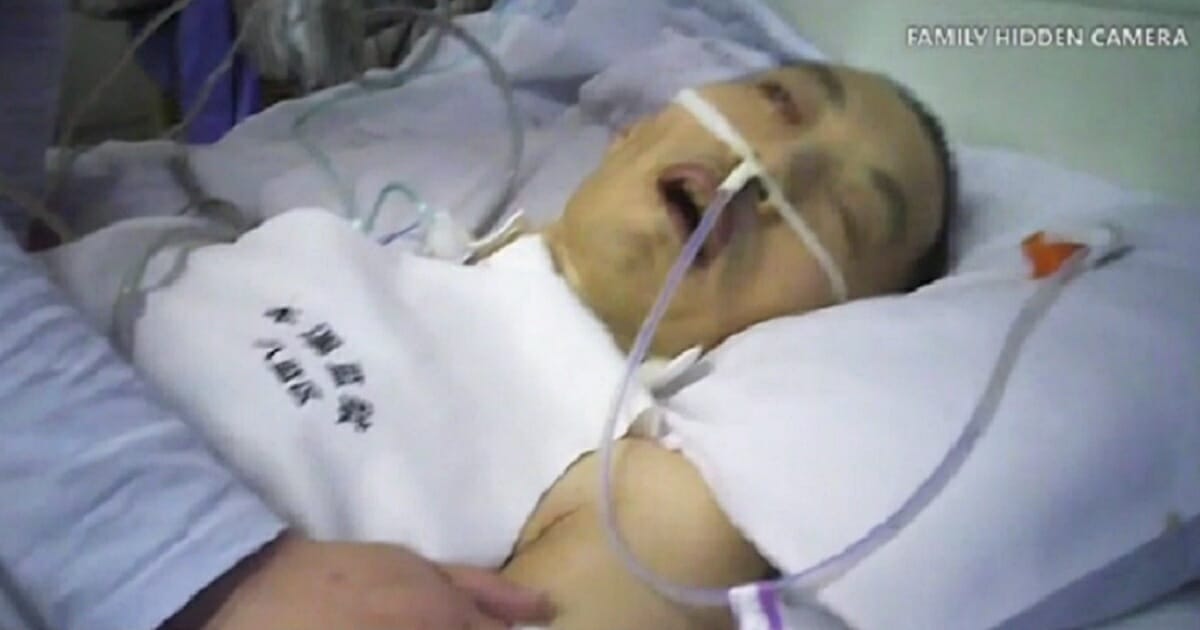 A purported torrture victim in a hospital bed in China.