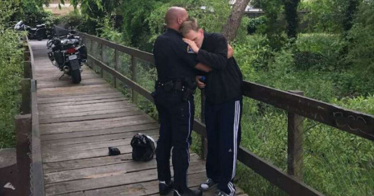 Cop hugging man with autism.