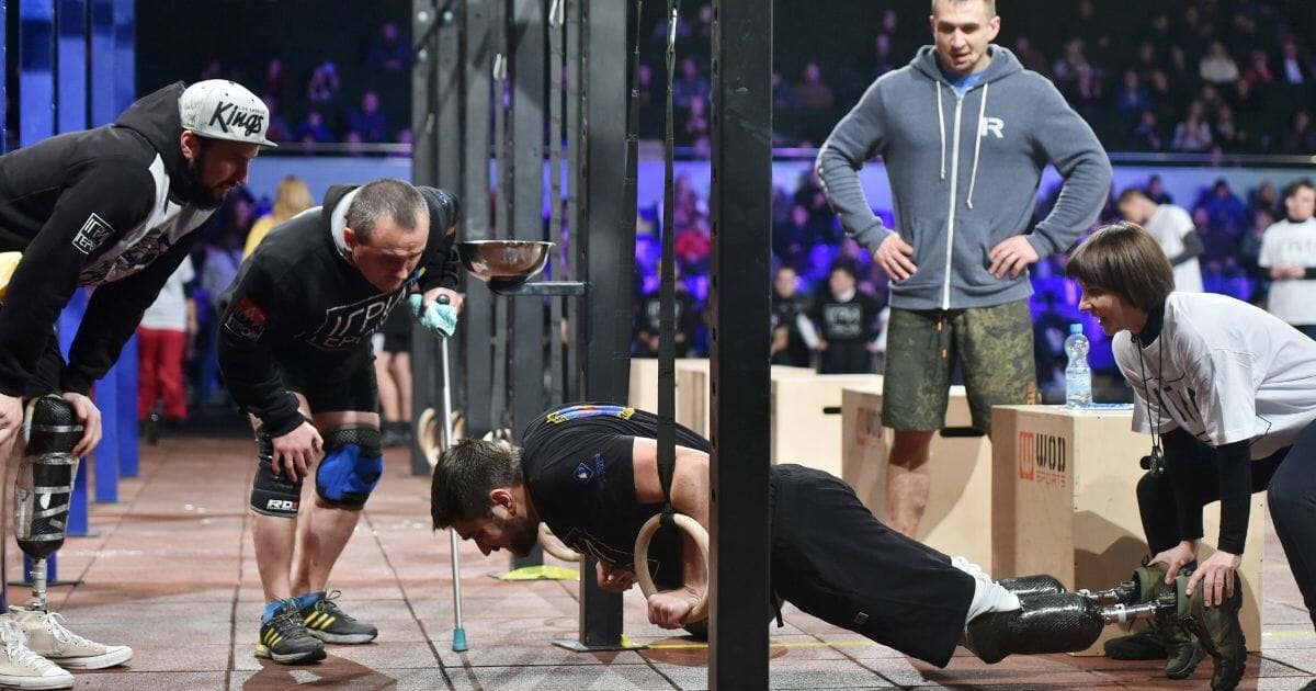 Competitors make exercises as they take part in the final competition for CrossFit Games called "Games of the Heroes" in Kiev on Dec. 24, 2016.