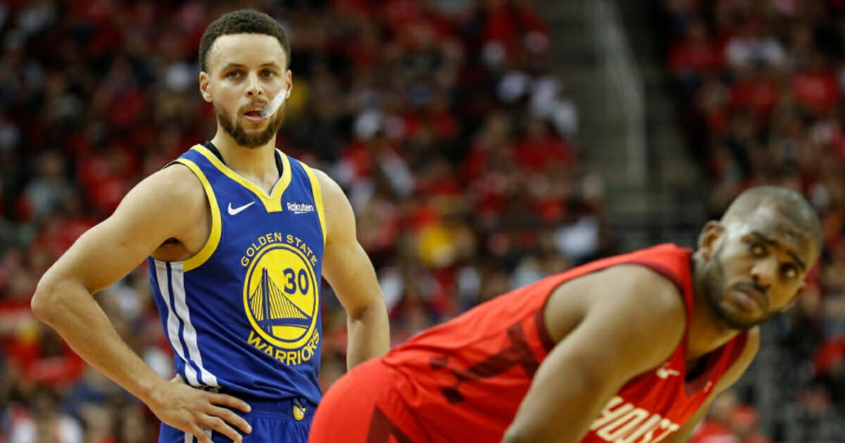 Golden State's Stephen Curry, left, and Houston's Chris Paul take a break during Game 3 of their playoff series May 4, 2019, in Houston.