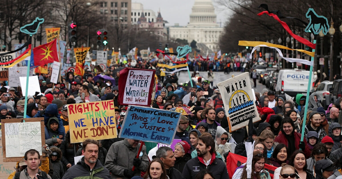 Protesters march in front of Capitol Hill to protest the Dakota Access pipeline