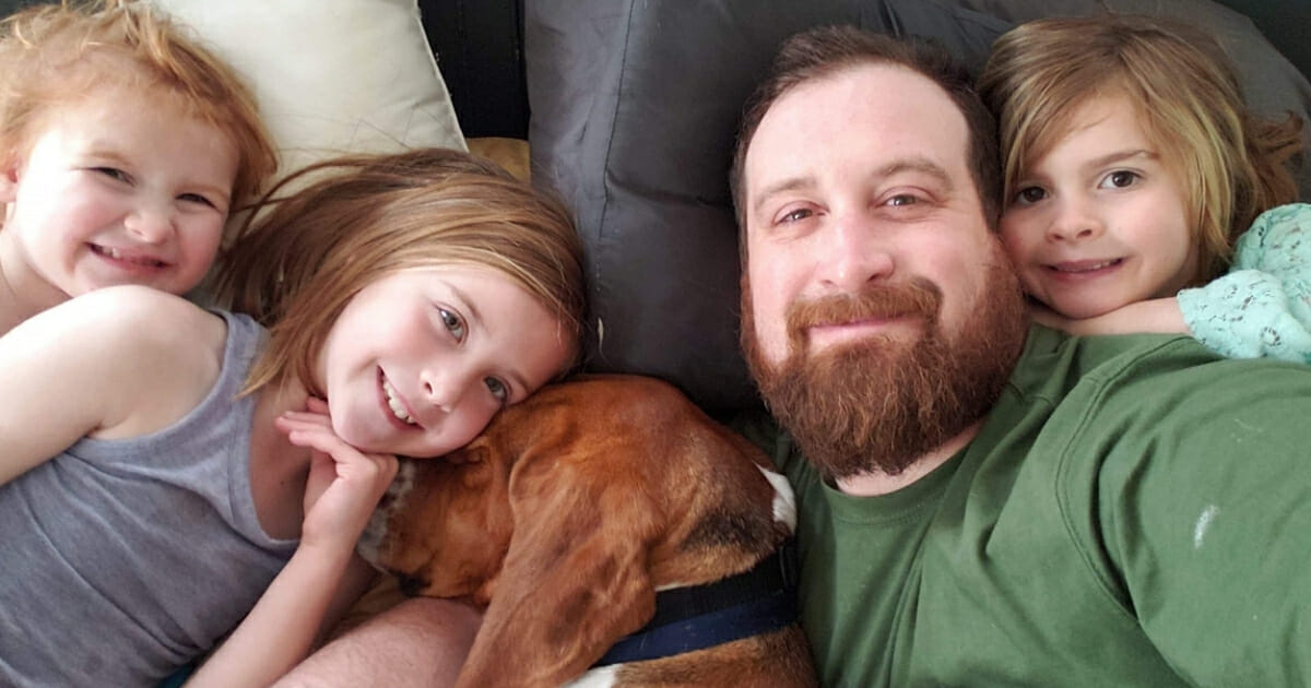 The family snuggled up with the hero dog.