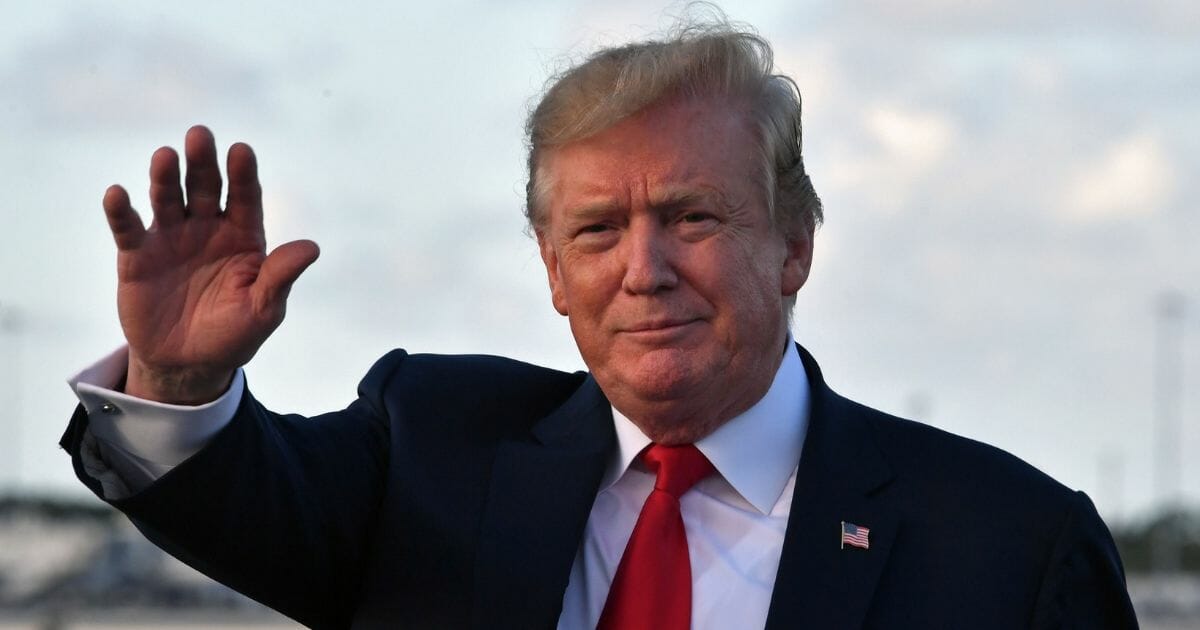President Donald Trump waves upon arriving at Palm Beach International Airport in Florida on April 18, 2019.