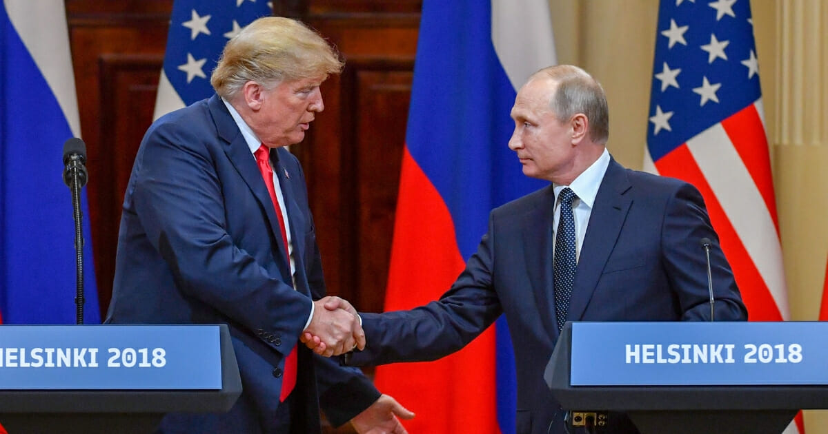President Donald Trump (left) and Russia's President Vladimir Putin shake hands before attending a joint press conference after a meeting at the Presidential Palace in Helsinki, on July 16, 2018.