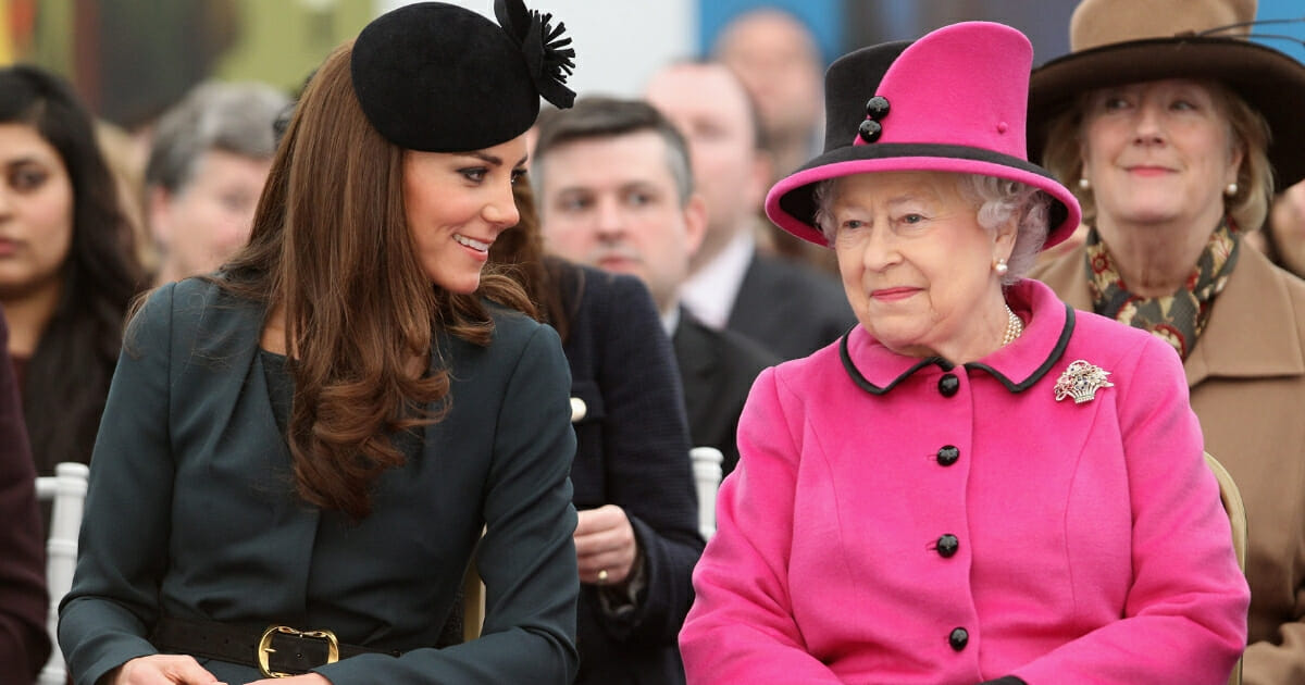 The Duchess of Cambridge and the Queen sit next to each other and talk.