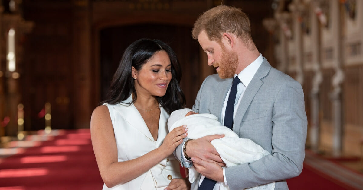 Meghan Markle and Prince Harry look down at their newborn baby boy.