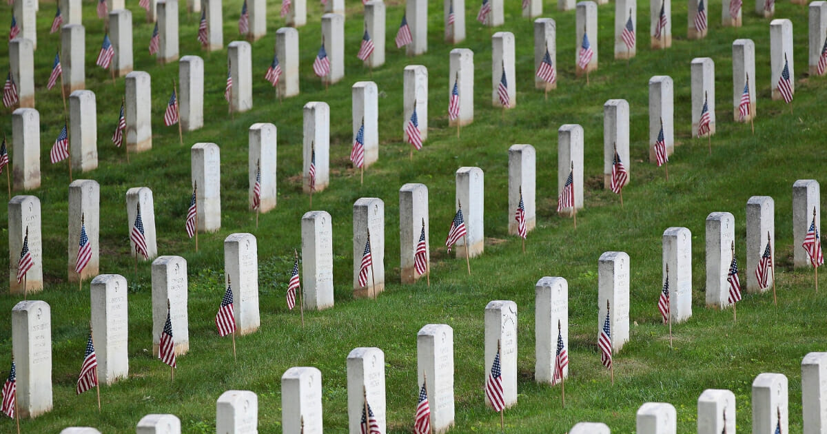 American flags adorn grave markers at the United States Soldiers' and Airmen's Home National Cemetery.