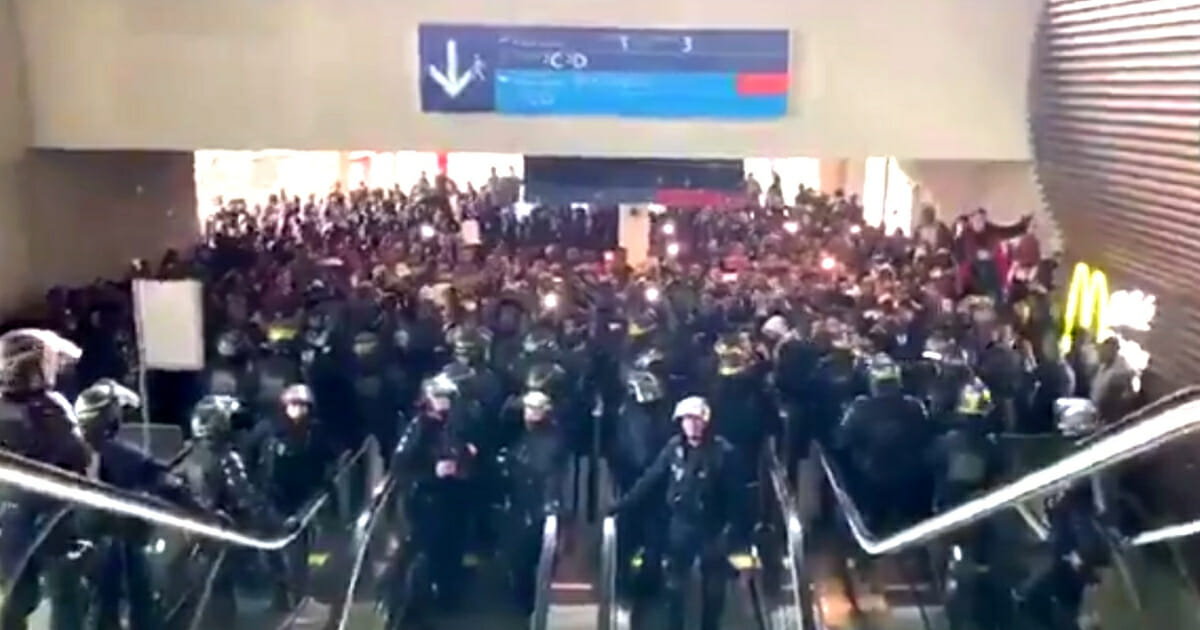 Hundreds of illegal immigrants face off against police officers in riot gear at France's Charles de Gaulle Airport.