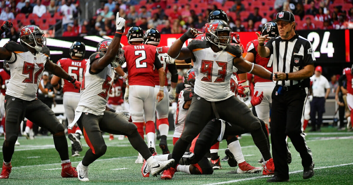 Gerald McCoy, right, and his Tampa Bay Buccaneers teammates celebrate a sack.