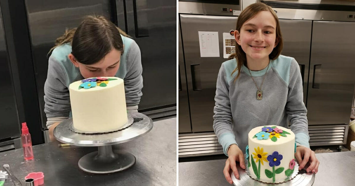 Girl decorates a cake.