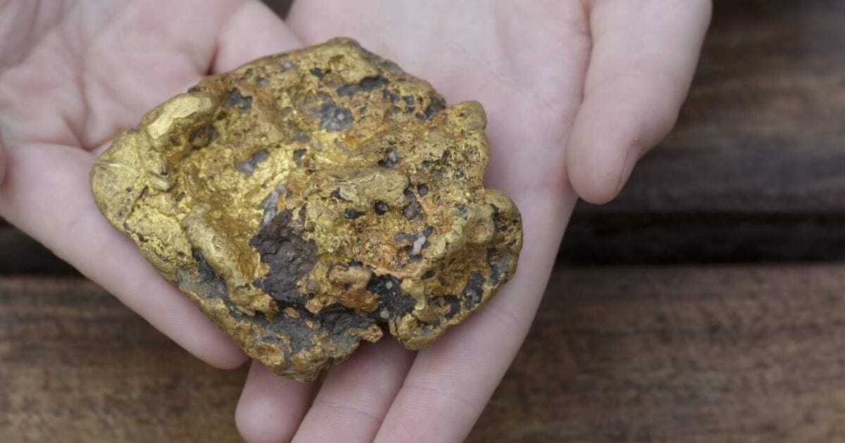 Gold nugget being held
