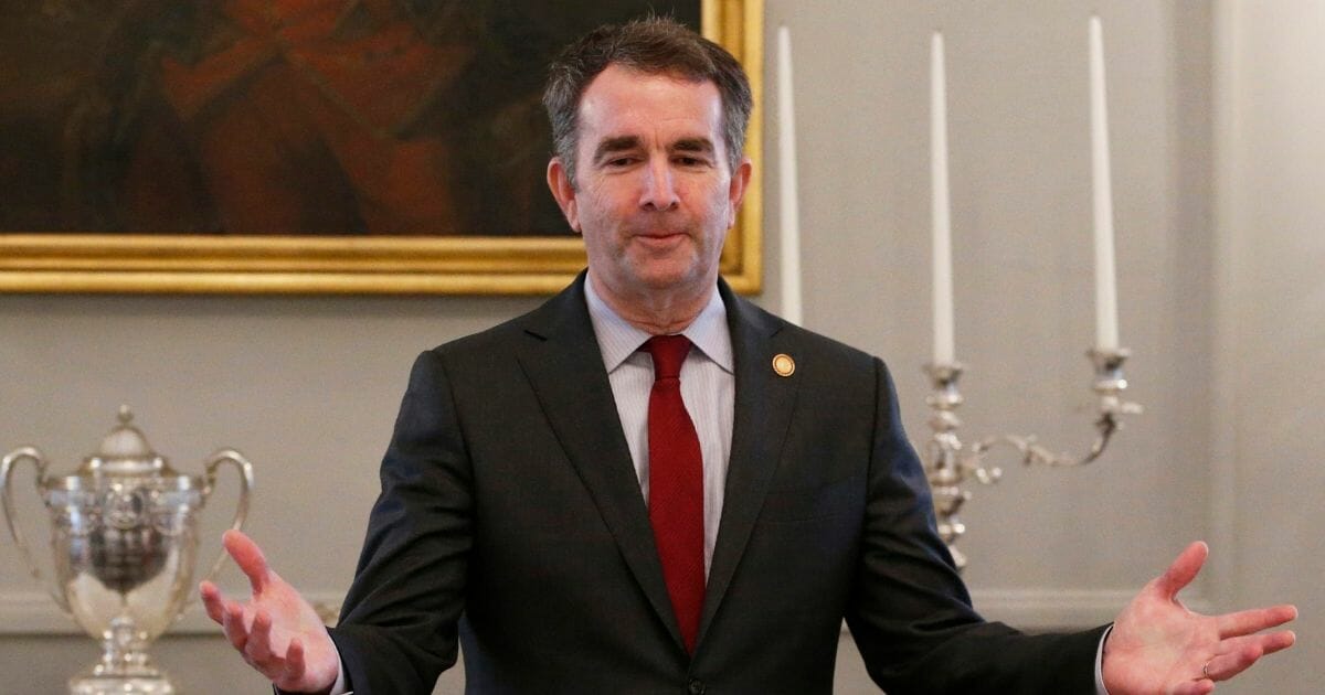 In this Friday, Feb. 22, 2019, file photo, Gov. Ralph Northam, center, greets members of the Richmond 34 and other African-American leaders for a breakfast at the Governors Mansion at the Capitol in Richmond, Virginia.