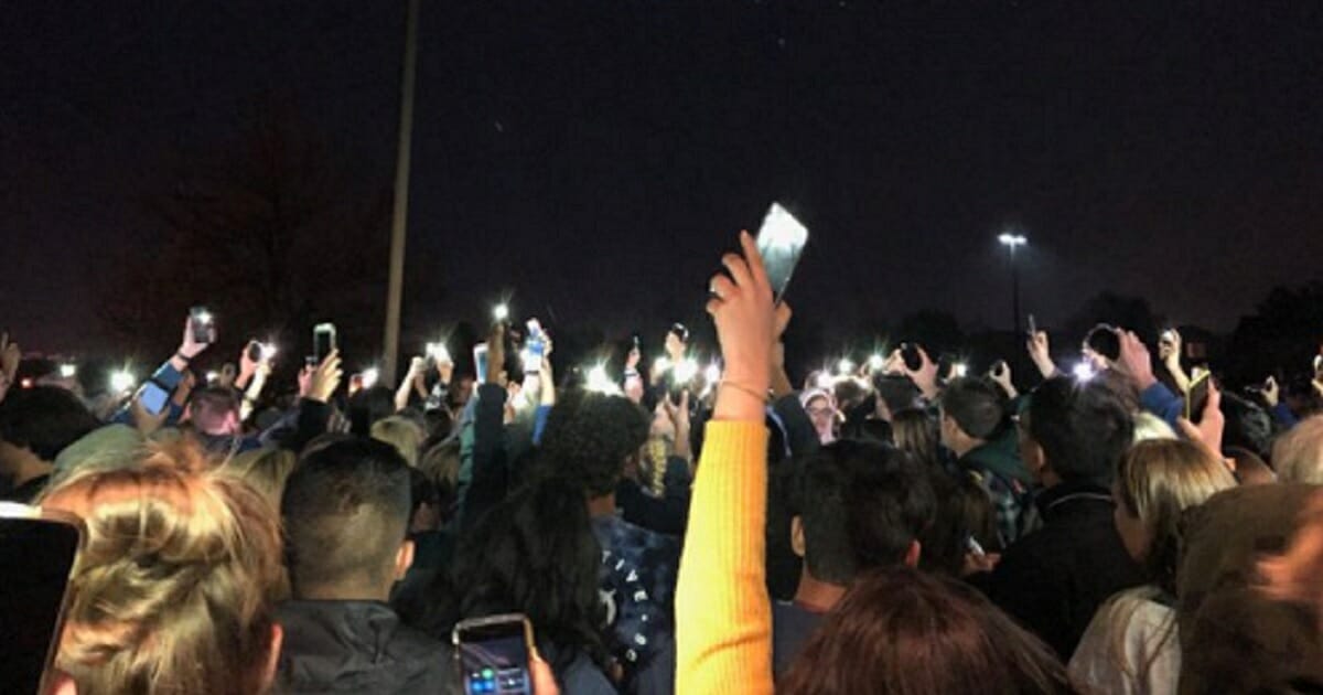 Students at the STEM School Highlands Ranch in Colorado conduct their own vigil for the victims of Tuesday's school shooting after storming out of a vigil that had taken an anti-gun political turn.