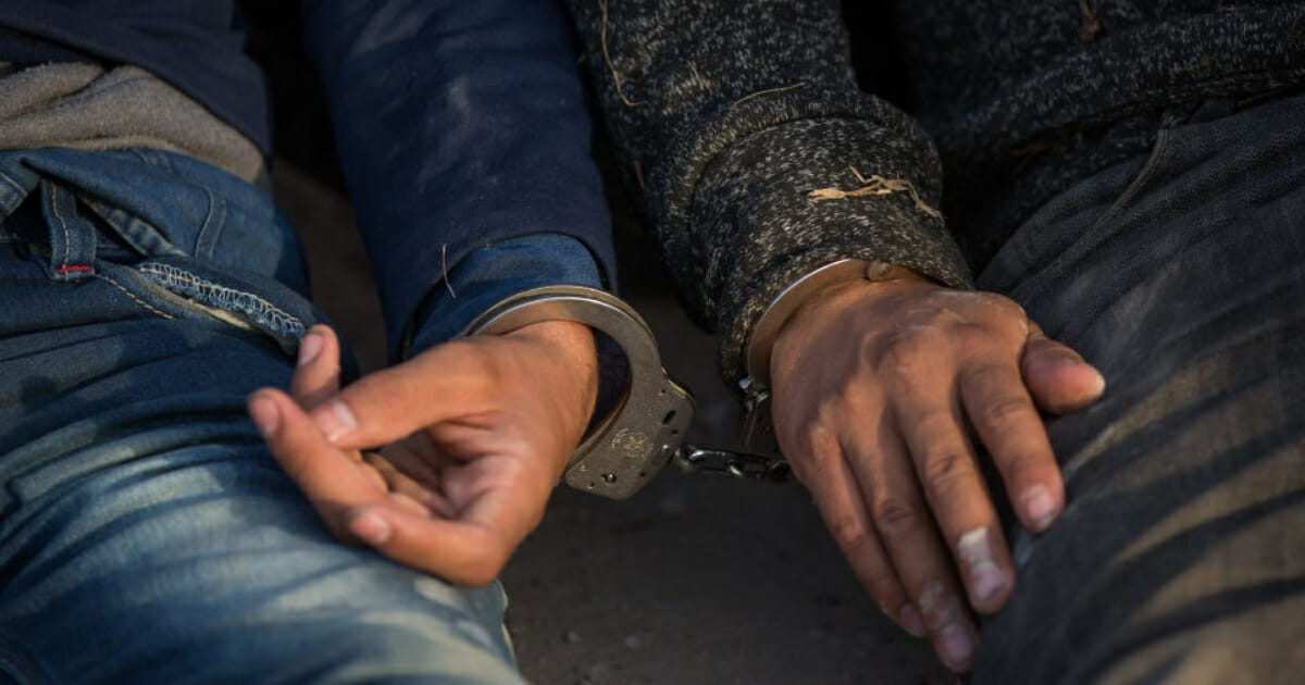 Illegal immigrants wait to be transported after they crossed the border from Mexico into the U.S. on March 26, 2018, near McAllen, Texas.