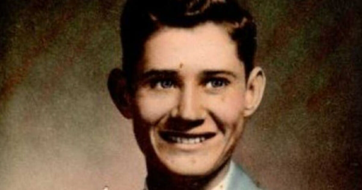 A young man smiles.
