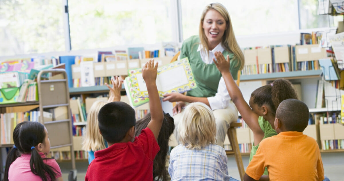 A teacher reads to kindergarten students.