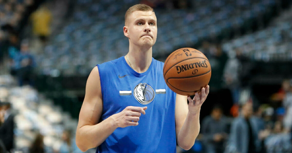 Dallas Mavericks forward Kristaps Porzingis holds a basketball.