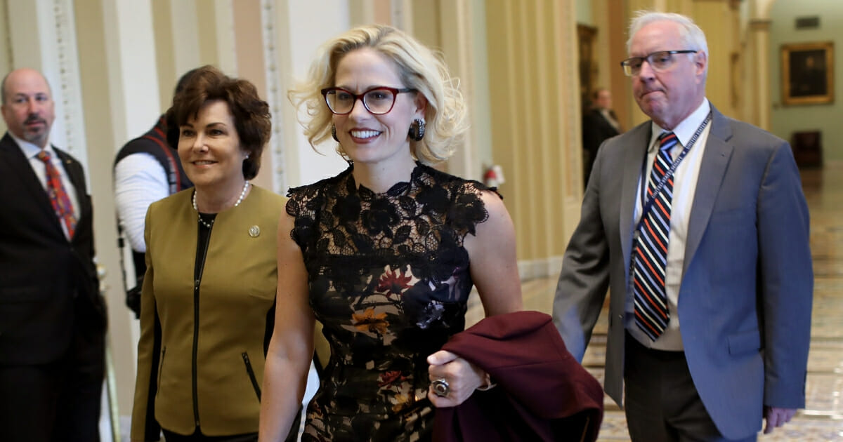Newly-elected Democratic Sens. Kyrsten Sinema and Jacky Rosen walk to the office of Senate Minority Leader Chuck Schumer for a meeting at the U.S. Capitol Nov. 13, 2018, in Washington, D.C.
