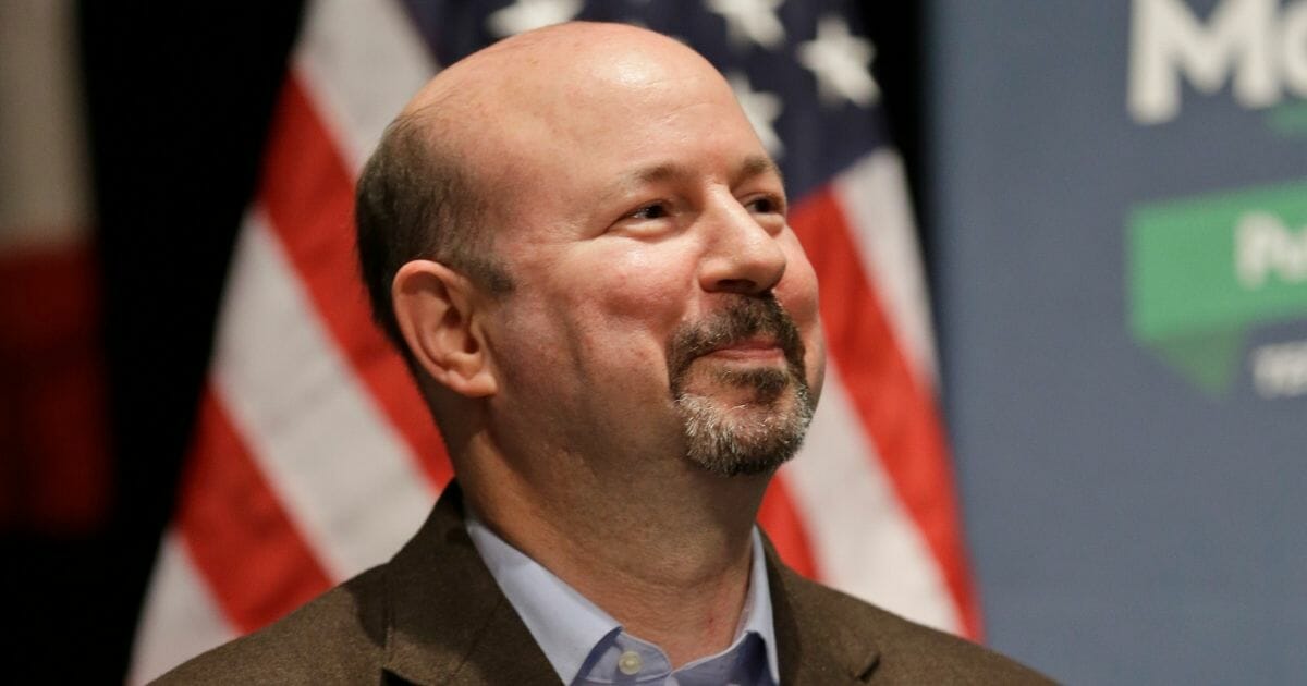 Climate scientist Michael Mann applauds during a rally for Terry McAuliffe in Charlottesville, Va., on Oct. 30, 2013.