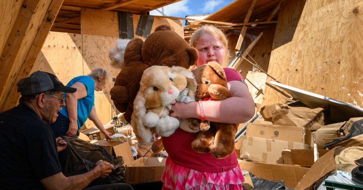 Keeley Frank holds stuffed animals salvaged from her grandparents' storage unit on Thursday, May 23, 2019, in Jefferson City, Mo.