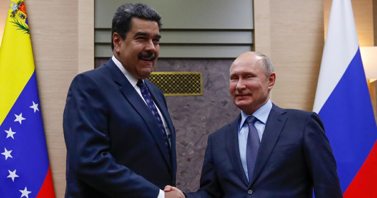 Russian President Vladimir Putin, right, shakes hands with his Venezuelan counterpart Nicolas Maduro during a meeting at the Novo-Ogaryovo state residence outside Moscow on Dec. 5, 2018.