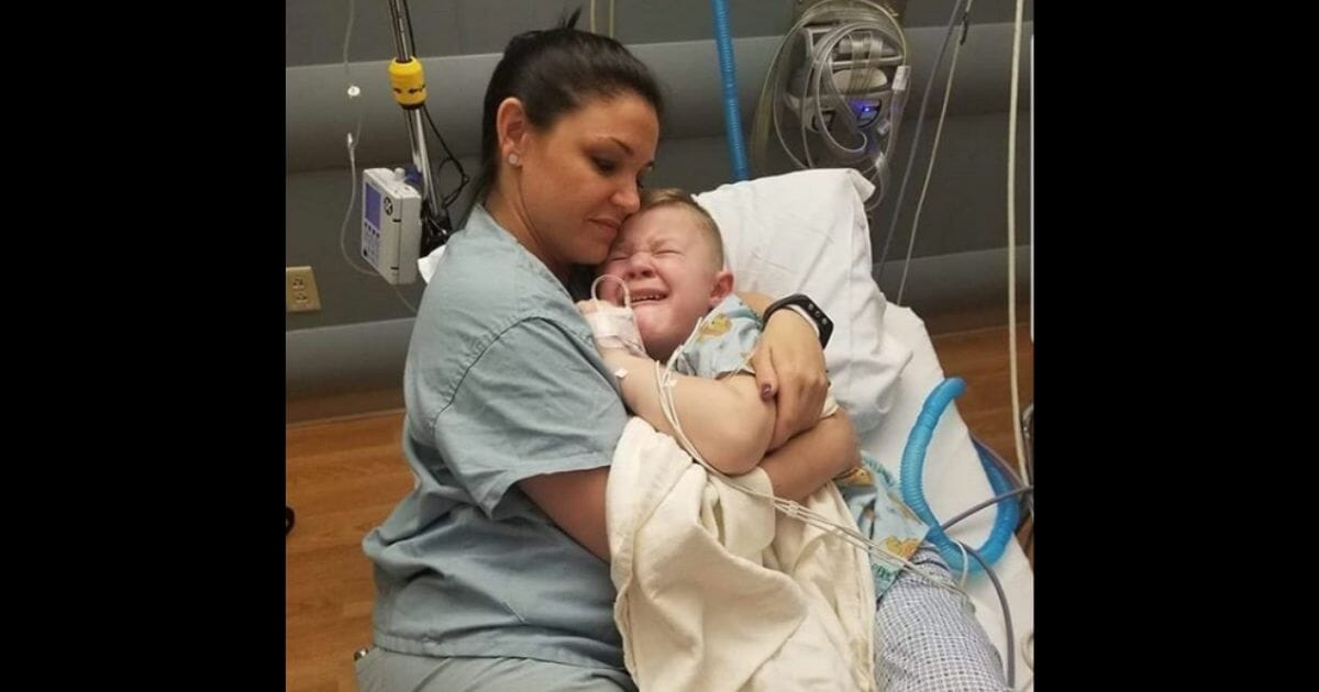 Nurse Hager cuddles up next to a crying Slade.