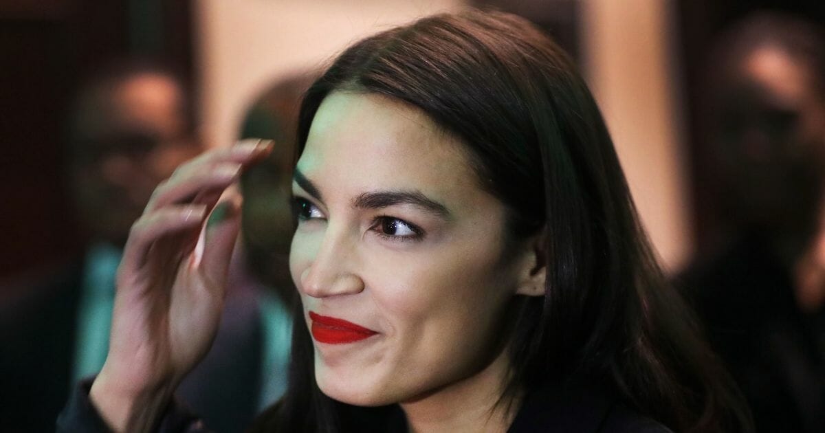 Rep. Alexandria Ocasio-Cortez prepares to speak at the National Action Network's annual convention on April 5, 2019, in New York City.