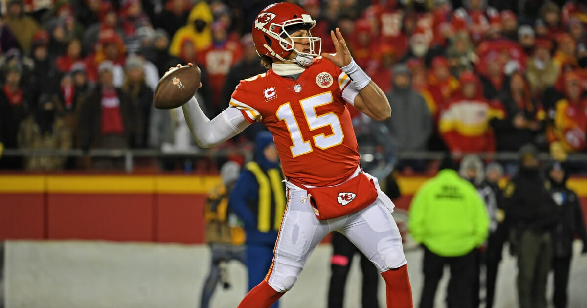 Quarterback Patrick Mahomes #15 of the Kansas City Chiefs throws a pass down field during the first half of the AFC Championship Game against the New England Patriots at Arrowhead Stadium on January 20, 2019 in Kansas City, Missouri.