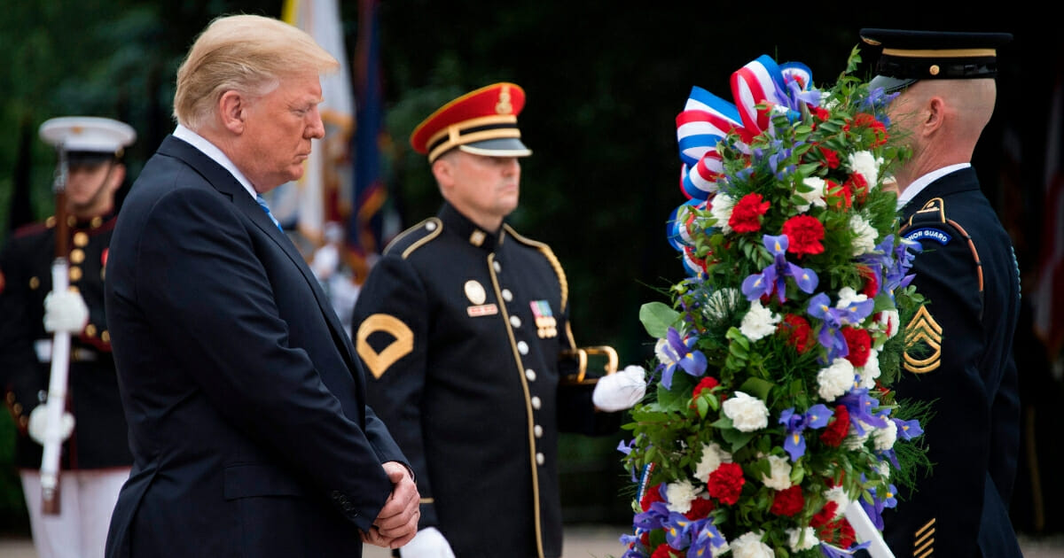 President Donald Trump lays a wreath at the Tomb of the Unknown Soldier.