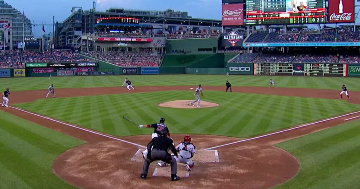 Anibal Sanchez of the Washington Nationals hits a ball up the middle toward St. Louis Cardinals pitcher Adam Wainwright.