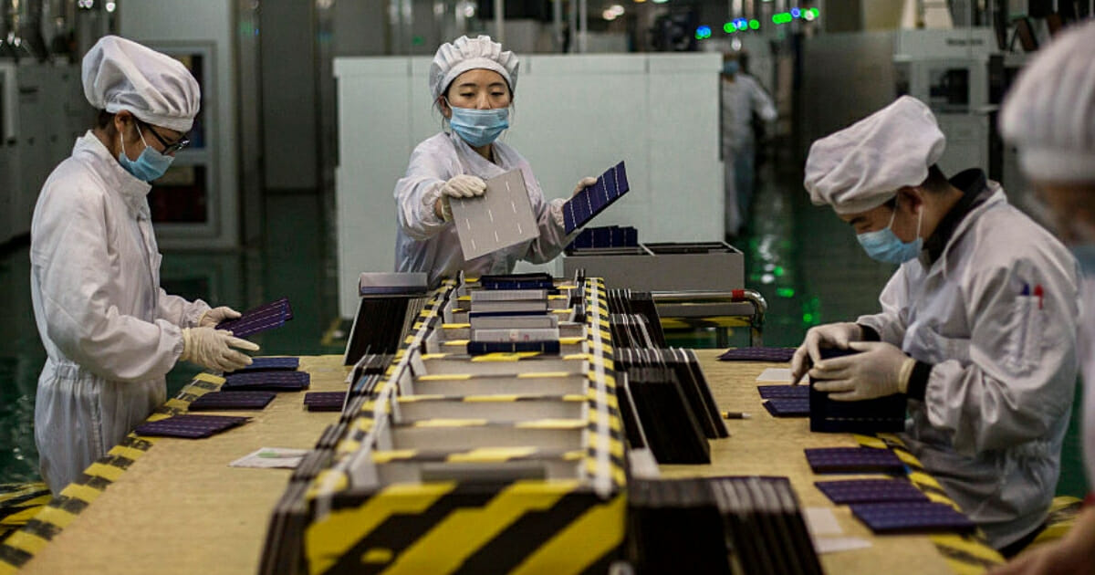 Technicians from Yingli Solar prepare solar cells used for solar panels at the company's headquarters in China.