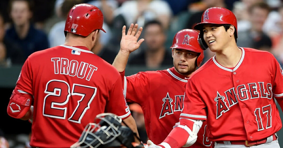 Mike Trout of the Los Angeles Angels celebrates with Shohei Ohtani and David Fletcher after hitting a two-run home run against the Orioles on Friday, May 10, 2019, in Baltimore.