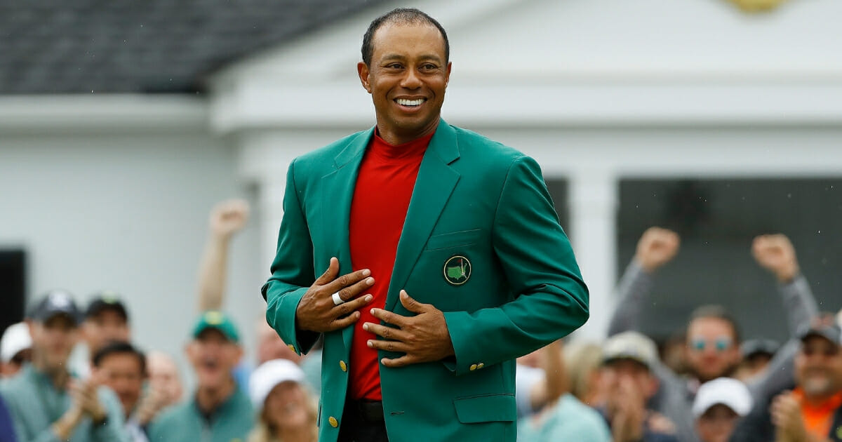 Tiger Woods smiles as he wears his green jacket after winning the Masters on April 14, 2019, in Augusta, Georgia.