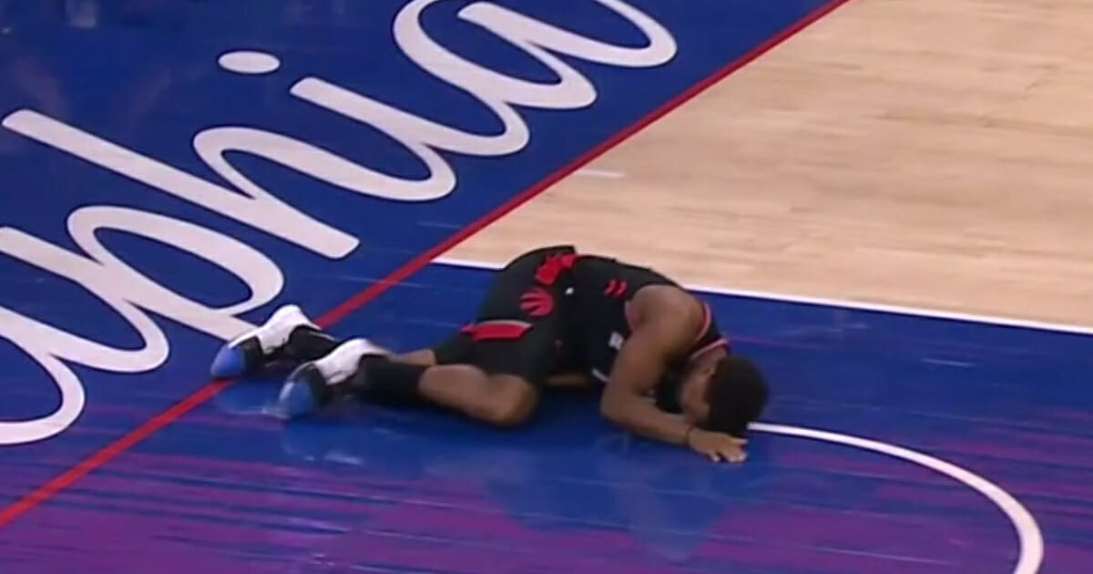 Toronto's Kyle Lowry lies on the court in pain.