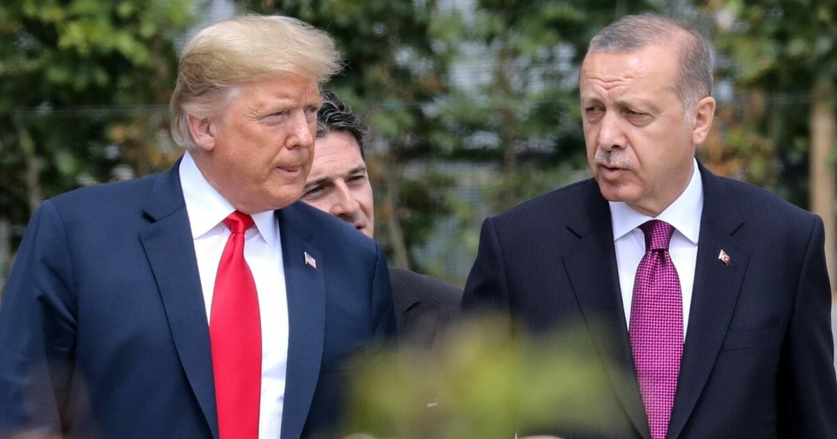 U.S. President Donald Trump speaks with Turkey's President Recep Tayyip Erdogan In Brussels, Belgium, on July 11, 2018.