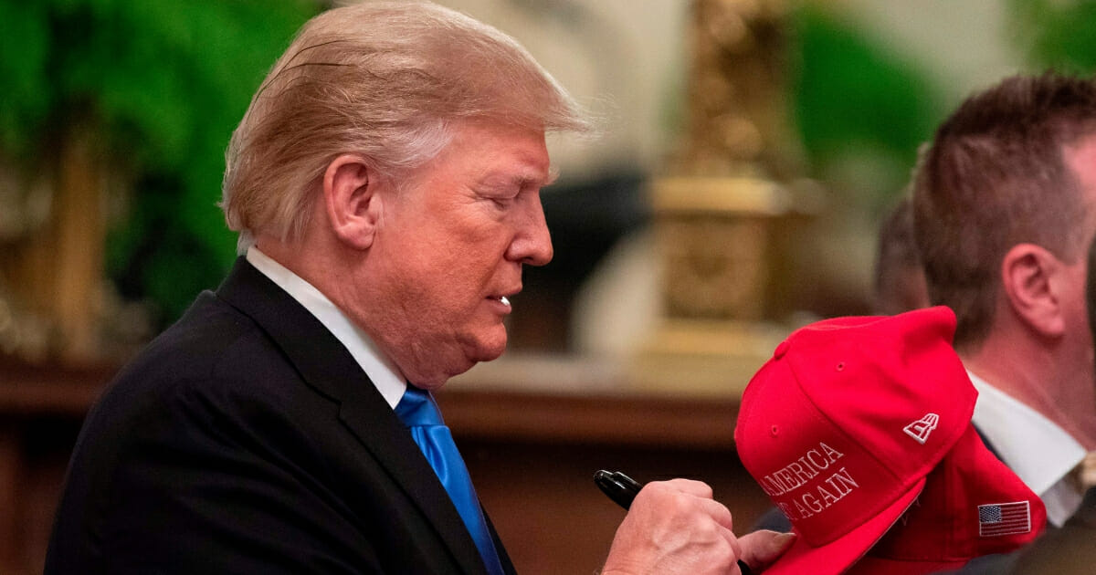 Trump Signs MAGA Hats
