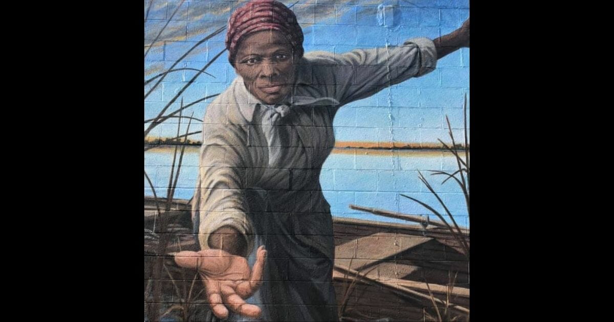 Picture of mural, with Tubman reaching down and offering her hand.