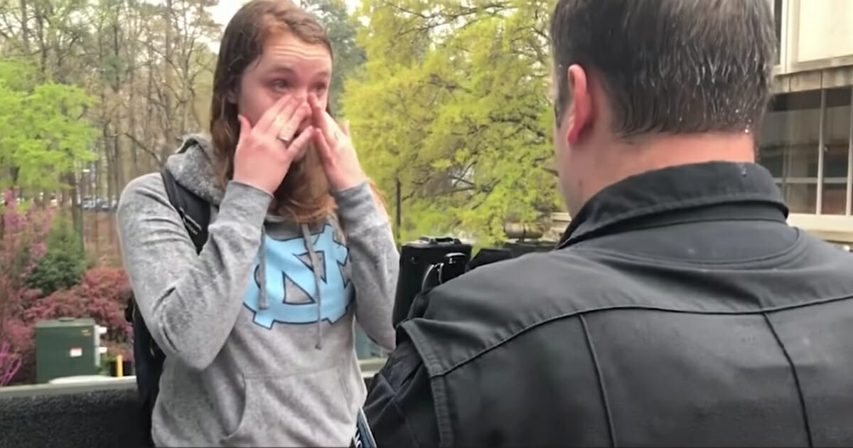 A student at the University of North Carolina-Chapel Hill is going viral for all the wrong reasons after she was arrested on camera for stealing the sign of pro-life activists. (CreatedEqualFilms / YouTube screen shot)