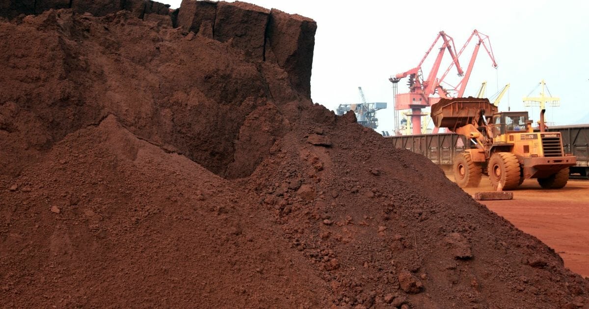 A front-end loader shifts soil.