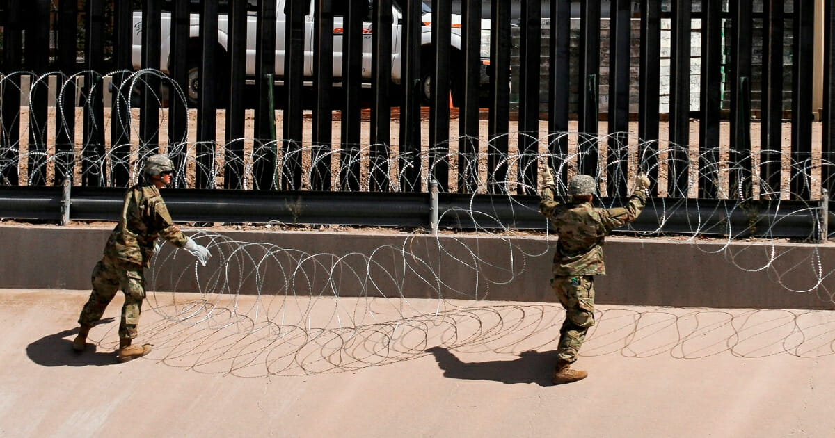 American soldiers install barbed wire by the US-Mexico border fence in El Paso, Texas, in early April.