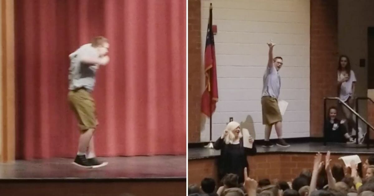 A boy dances across the stage to accept an award.