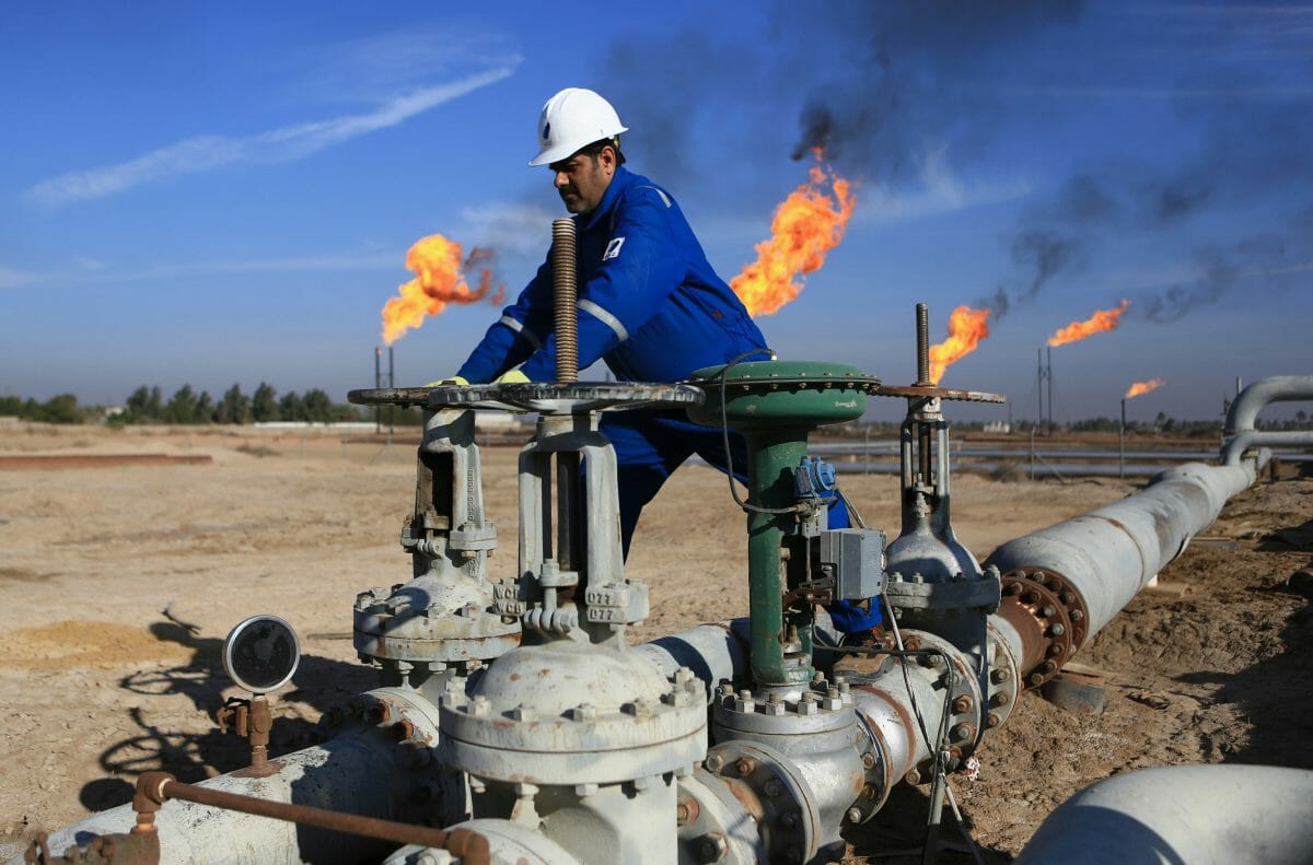 A worker operates valves in Nihran Bin Omar field north of Basra, Iraq.